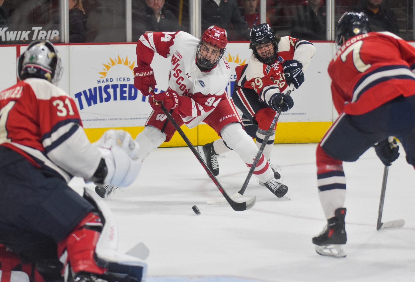 vasily zelenov eyes the puck with three robert morris players near him