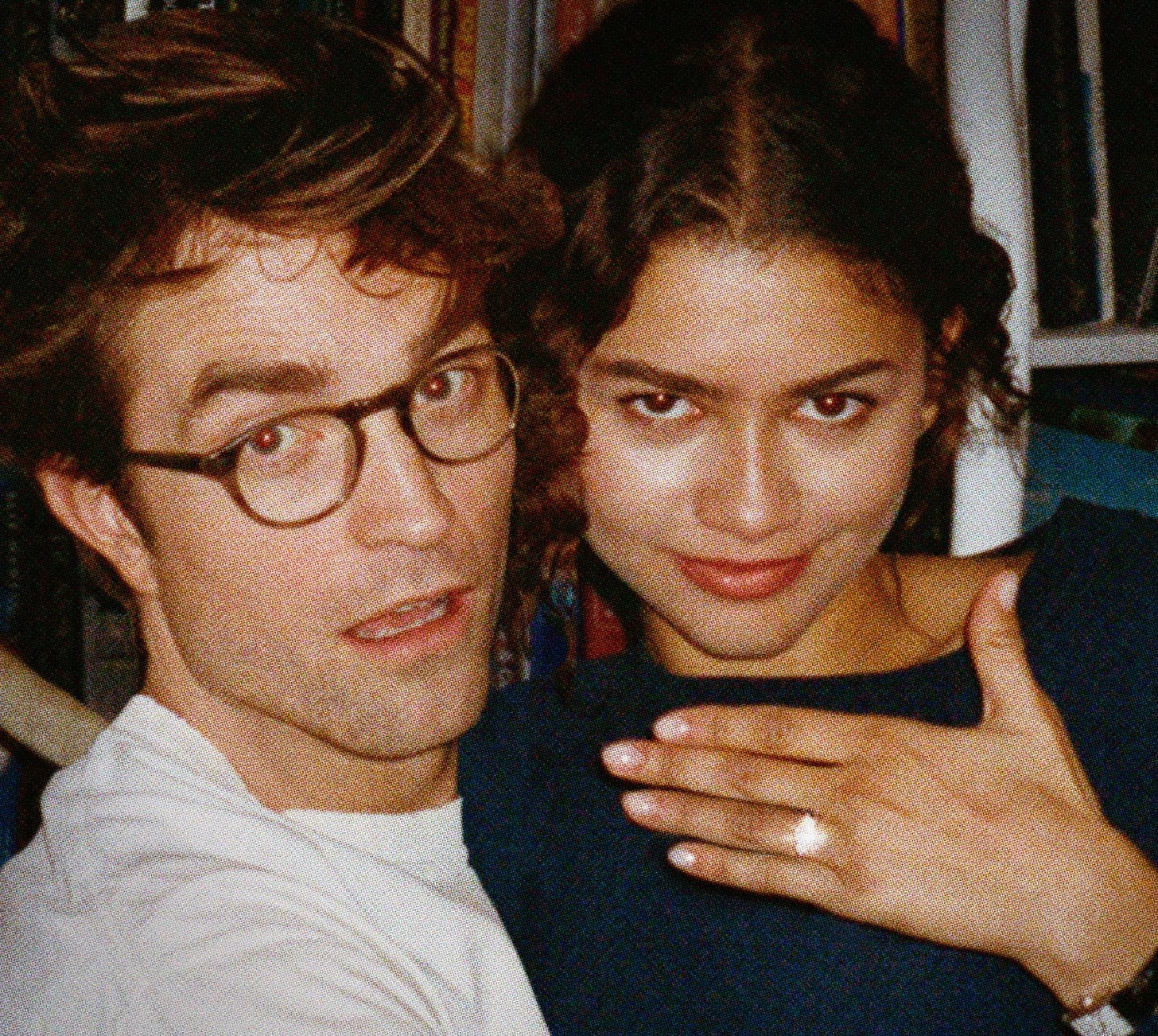 Zendaya and Robert Pattinson in a grainy, close-up still from The Drama, posing together as her ringed hand rests across her chest.