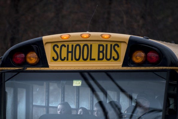 A school bus takes students to Newtown High School December 18, 2012 in Newtown, Connecticut. Students in Newtown, excluding Sandy Hook Elementary School, return to school for the first time since last Friday's shooting at Sandy Hook which took the live of 20 students and 6 adults.  AFP PHOTO/Brendan SMIALOWSKI        (Photo credit should read BRENDAN SMIALOWSKI/AFP/Getty Images)