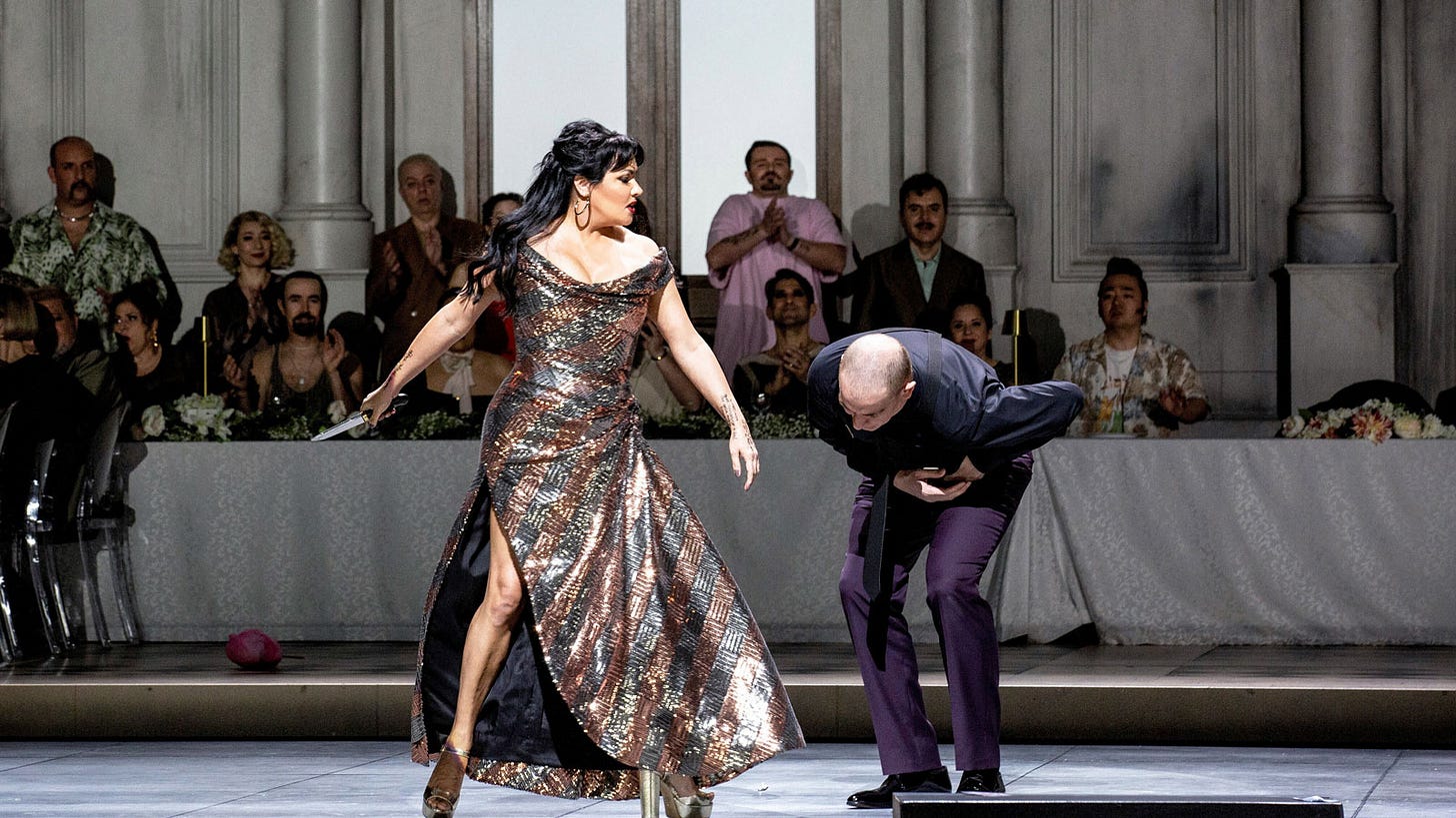 Anna Netrebko as La Gioconda, slashing a dagger at Tariq Nazmi (Alvise)