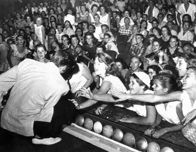 Elvis performing and engaging the crowd at the Olympia Theater on Friday, August 3, 1956. Courtesy of Florida State Archives. Elvis performing and engaging the crowd at the Olympia Theater on Friday, August 3, 1956. Courtesy of Florida State Archives.