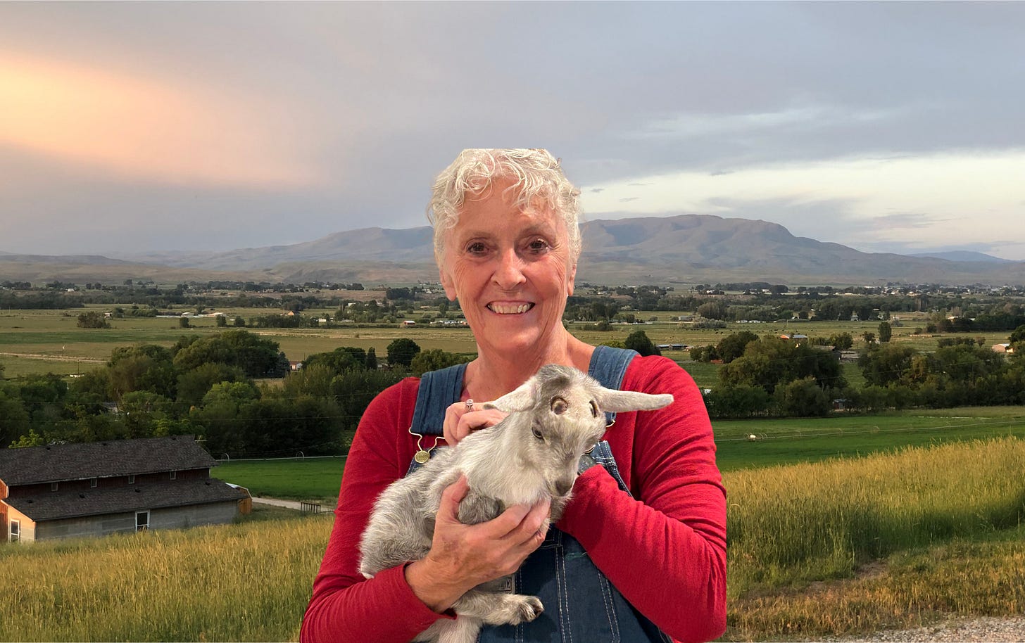 Picture of me and one of my goats with the valley in the background.