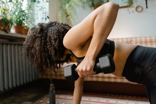 Free A Woman Holding a Dumbbell Stock Photo