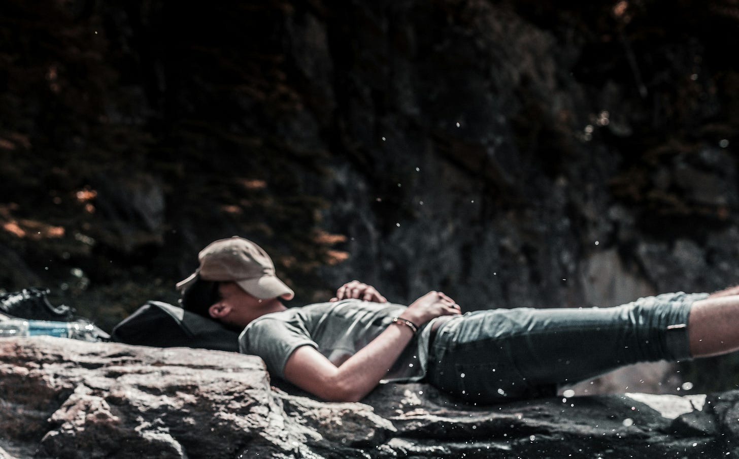 man resting on rocks man resting on rocks