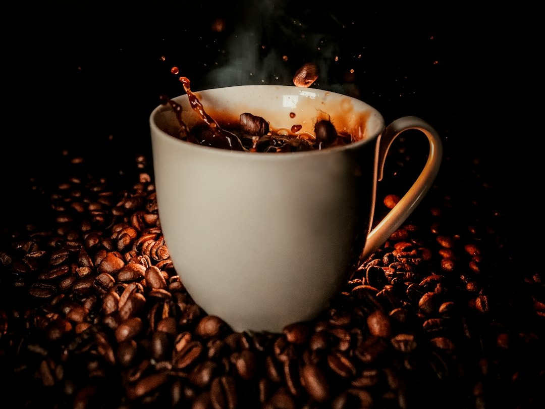 white ceramic teacup with coffee beans white ceramic teacup with coffee beans