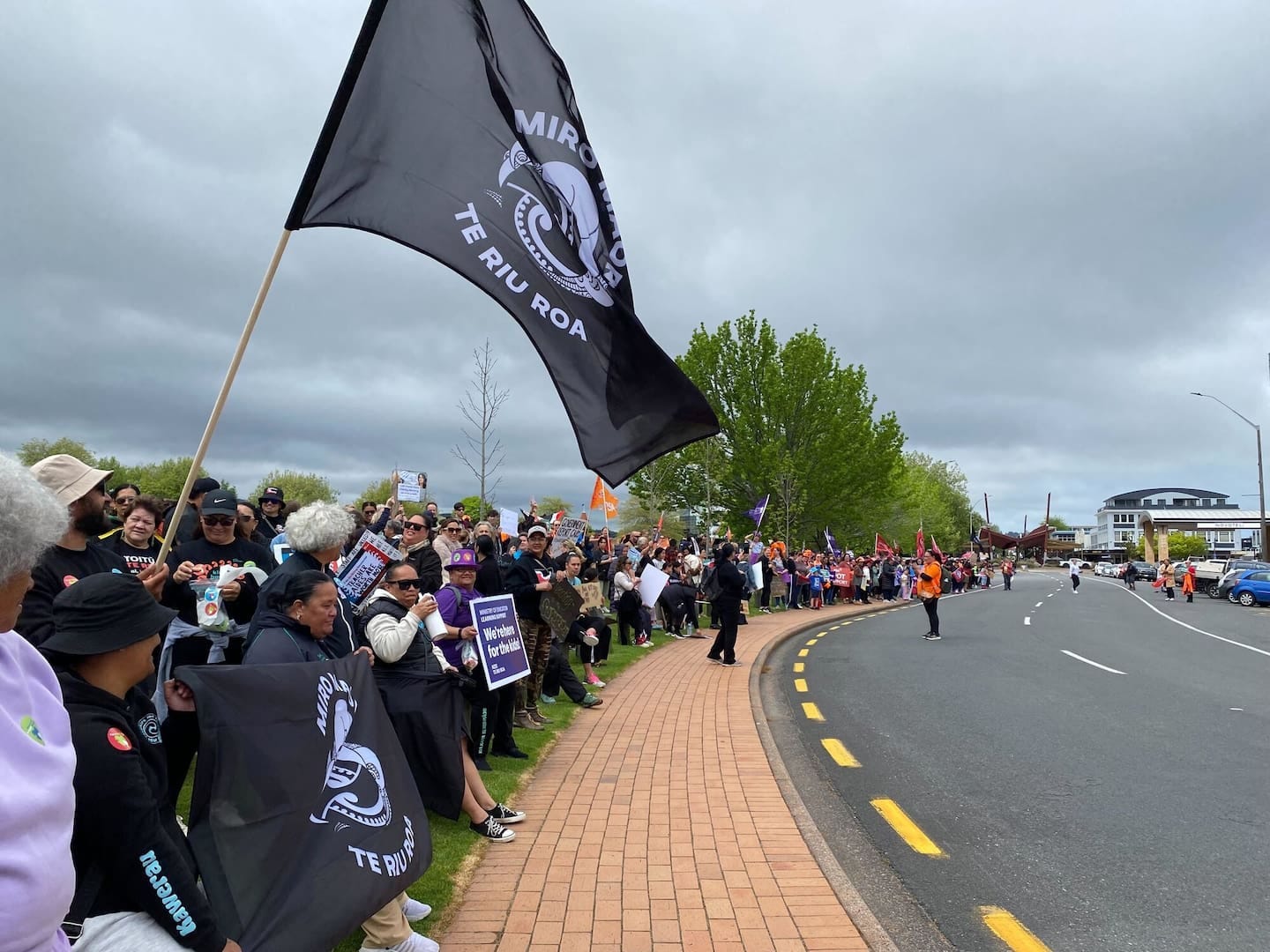Hundreds of Rotorua strikers gathered along Tutanekai St holding signs and flags.
