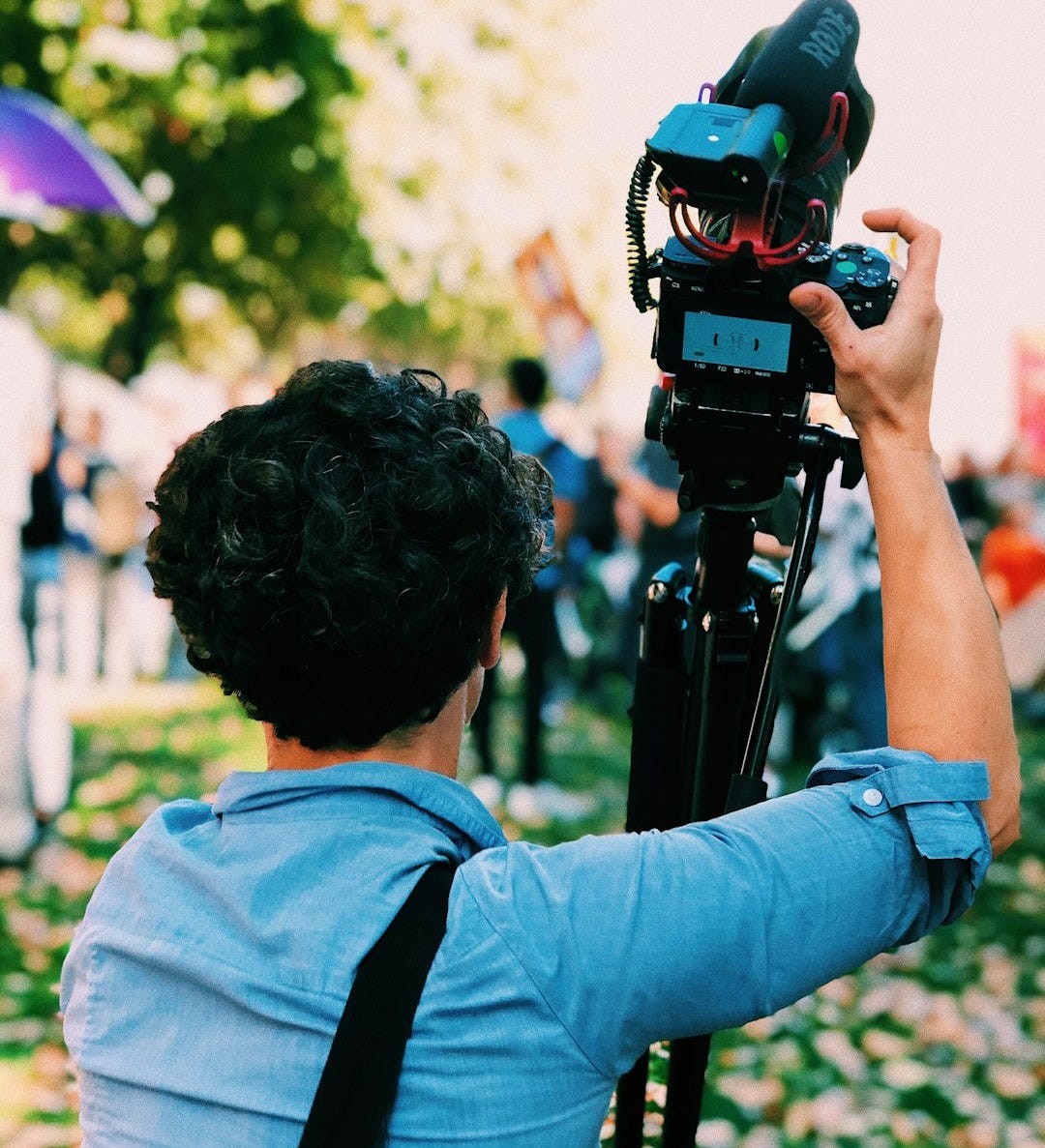 man holding DSLR camera man holding DSLR camera