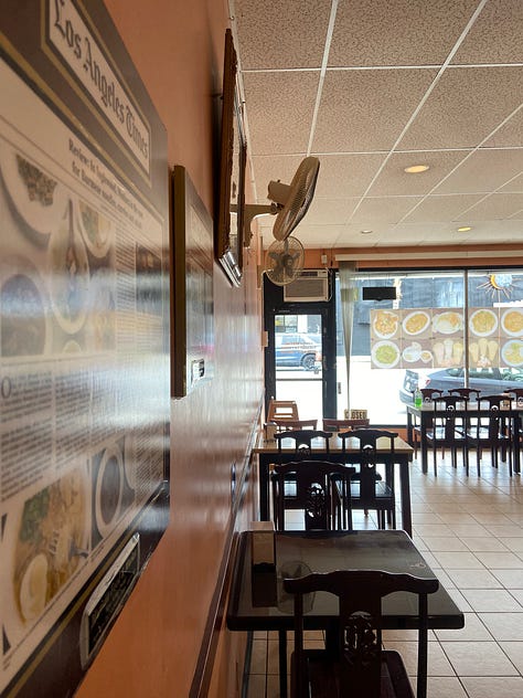 Mutiara from the inside. Warm pink walls. Plain cherry stained chairs. A small asian halal market. Minimal decor. 