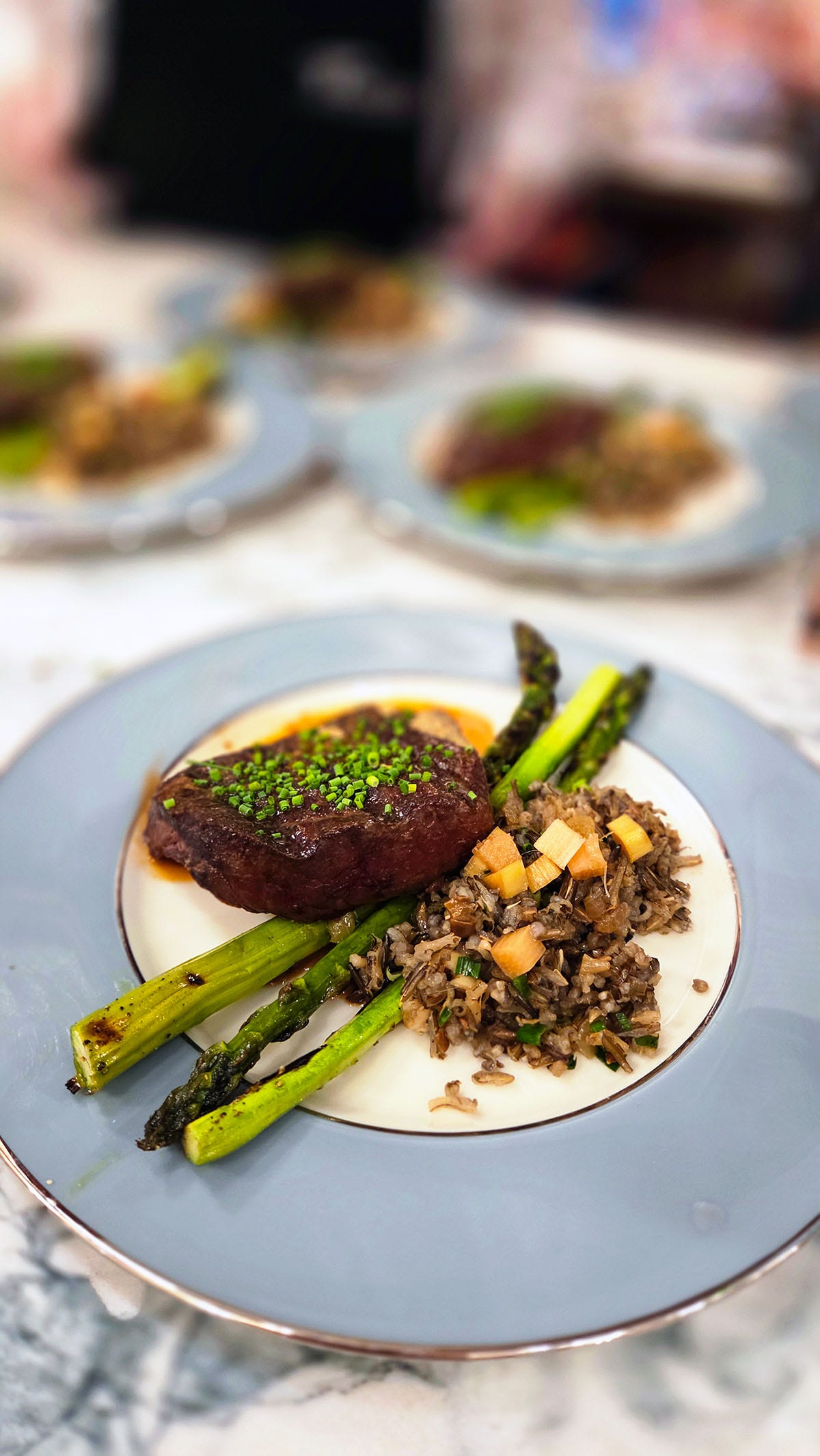 Elk loin with asparagus and wild rice on a plate, ready to be served. Elk loin with asparagus and wild rice on a plate, ready to be served.