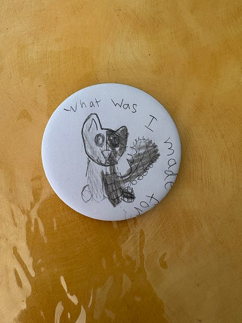 2 photos of USPS stickers with drawings and writings on them, and a button with a pencil drawing of a stuffed animal that reads "What was I made for?"
