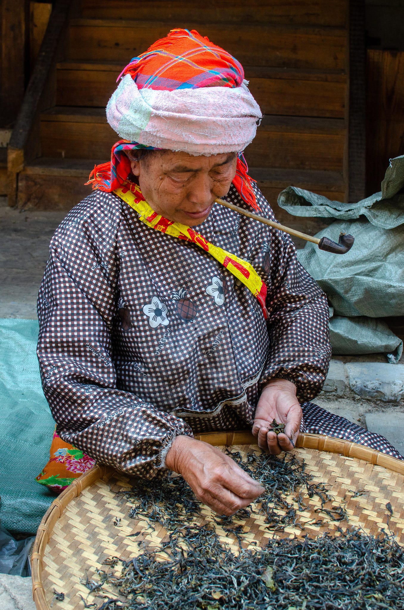 ID: Woman sorting tea leaves