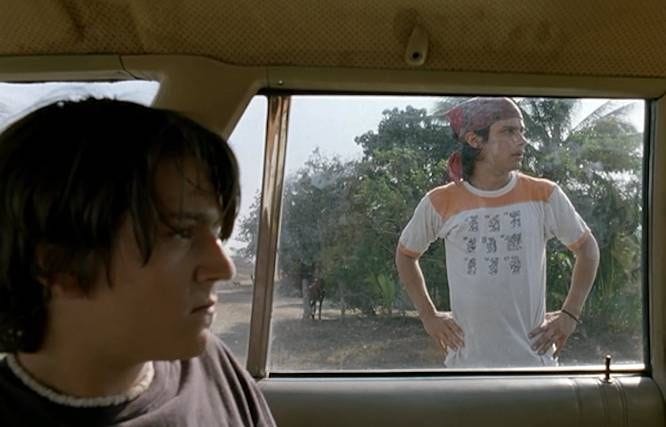 This may contain: a man sitting in the back seat of a car looking at another man with his hands on his hips This may contain: a man sitting in the back seat of a car looking at another man with his hands on his hips