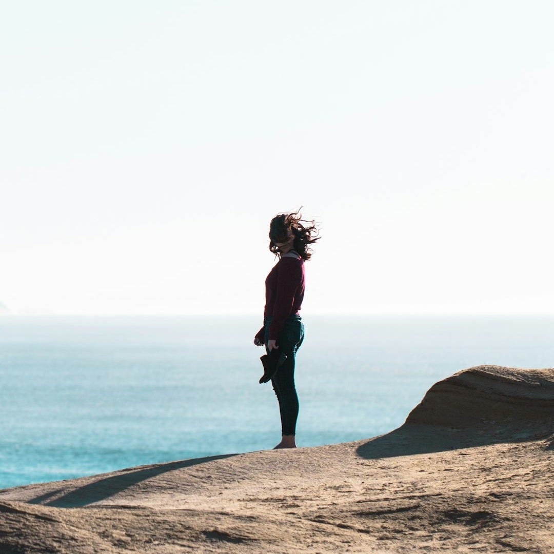 woman standing near body of water