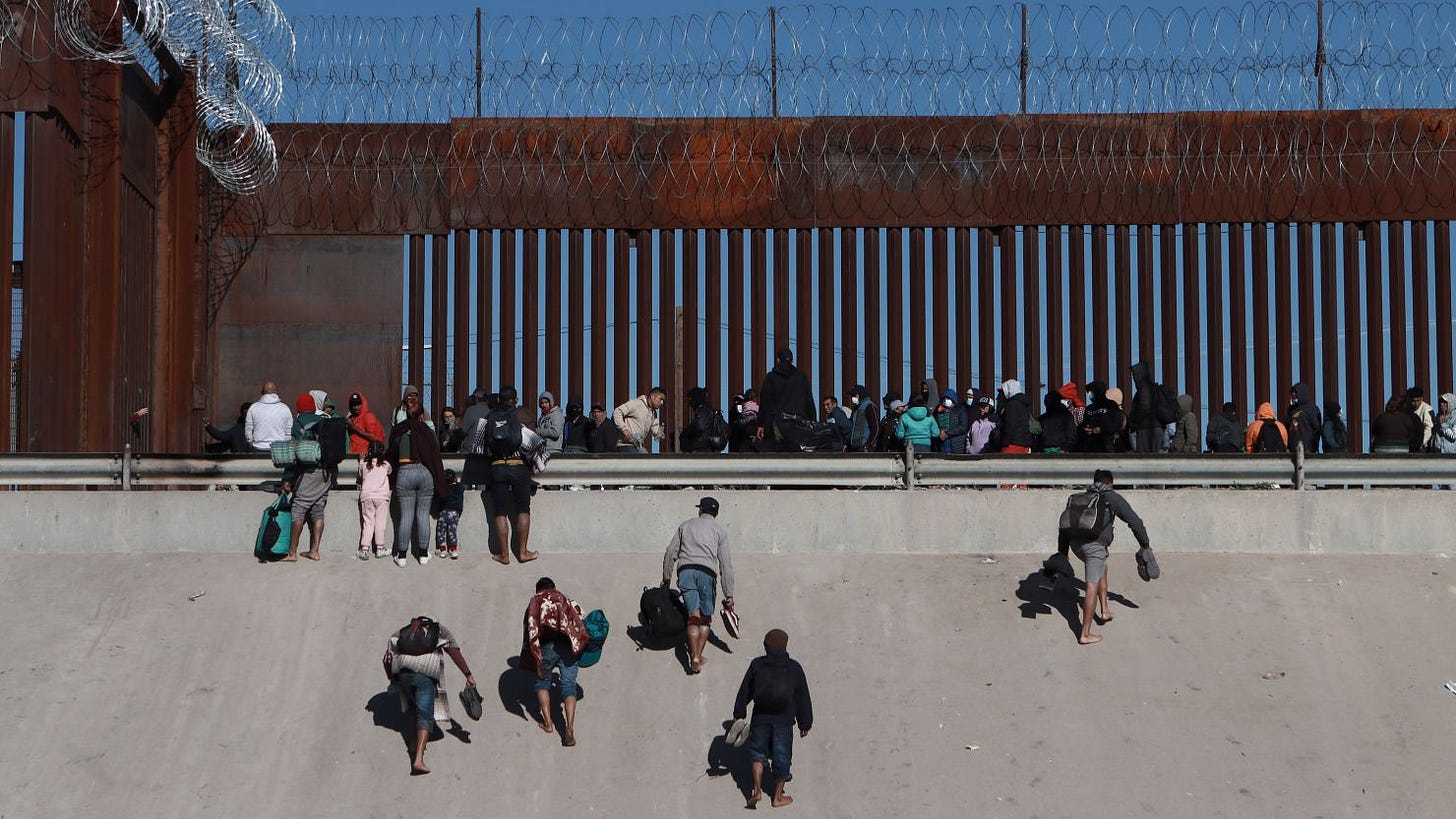 Migrants approach the border wall in Ciudad Juarez, Mexico, on Wednesday, December 21, 2022, on the other side of the border from El Paso, Texas. Migrants approach the border wall in Ciudad Juarez, Mexico, on Wednesday, December 21, 2022, on the other side of the border from El Paso, Texas.