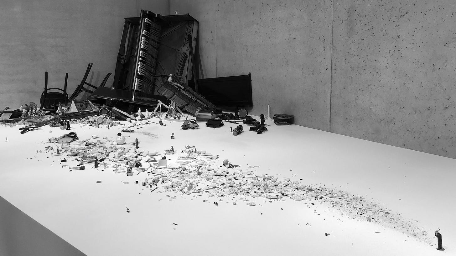 Photo of small figurine of man with an axe breaking down material and leaving a trail of debris decreasing in size.