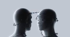 Two mannequin heads facing each other, joined by barbed wire.