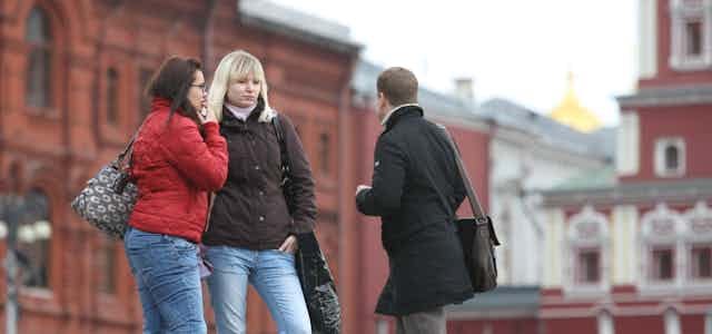 Two women and a man in Red Square, Moscow.