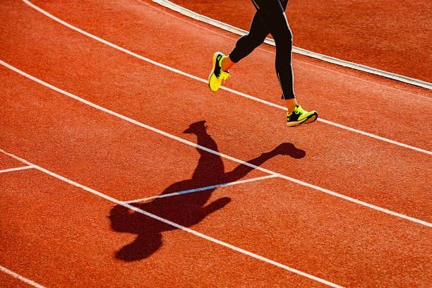 sportsperson running over the running track - running stock pictures, royalty-free photos & images