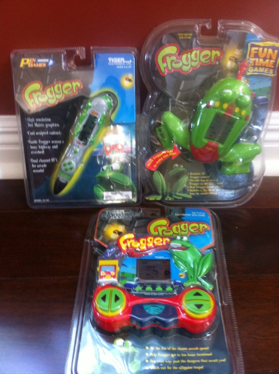 A photograph showing three toys based on Frogger. A photograph showing three toys based on Frogger.