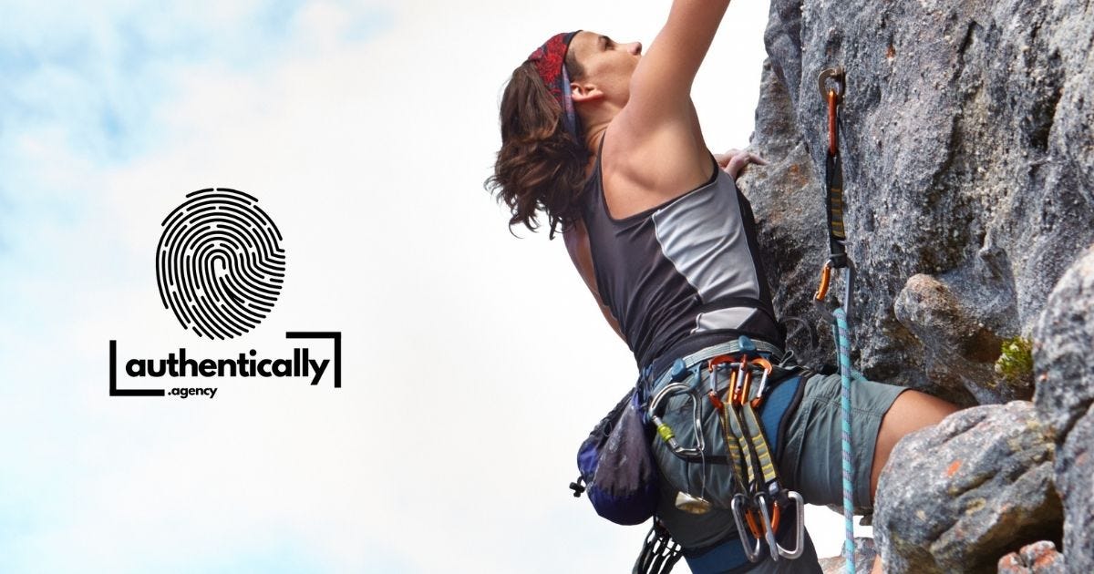 Woman climbing a mountain with mountain climbing equipment - focused on the task