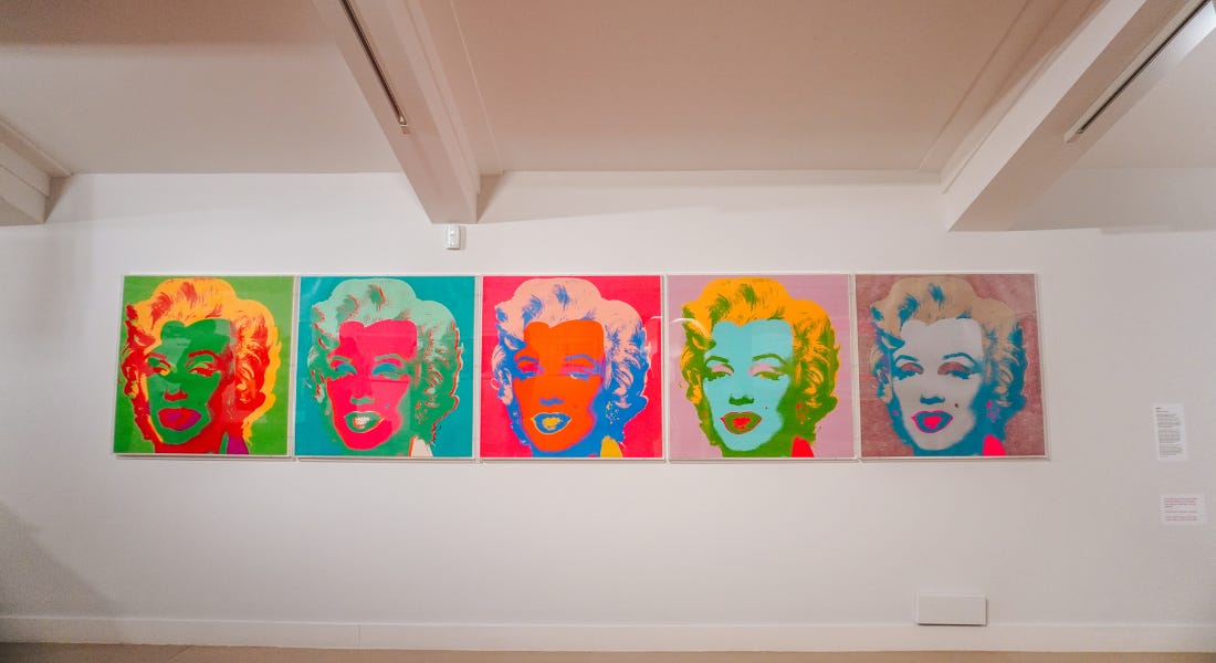 Five Andy Warhol Marilyn Monroe pictures hung up on a white wall Five Andy Warhol Marilyn Monroe pictures hung up on a white wall