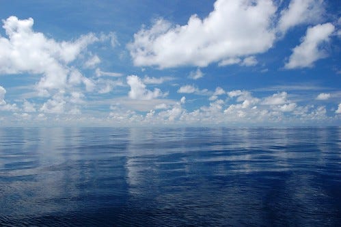 Blue ocean with white clouds
