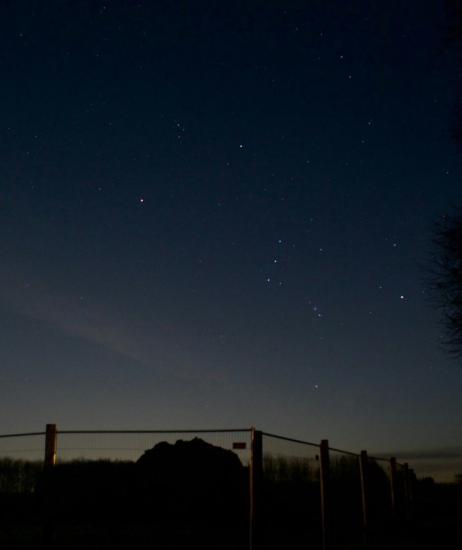 the night sky with stars above a fence the night sky with stars above a fence