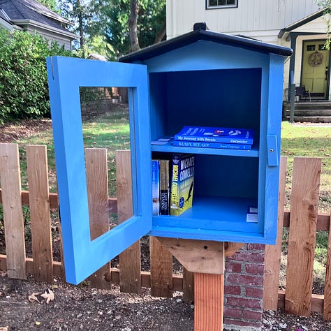 Steps to build a little library, digging a hole, pouring cement, sawing the wood, priming and painting, filling with books