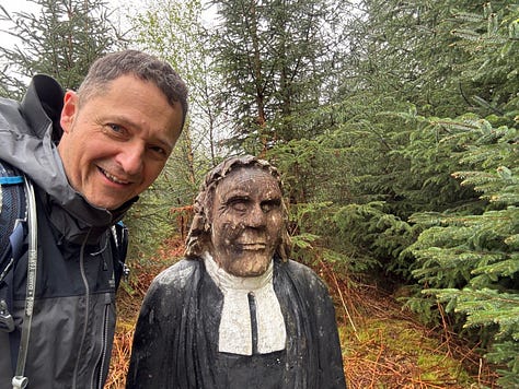 A local wood carving on the trail, a wet top, and a view of the Grey Corries