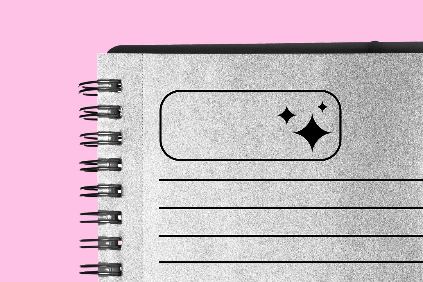 Close up of a paper journal with a block that shows the Gemini symbol on top of a pink backgroun