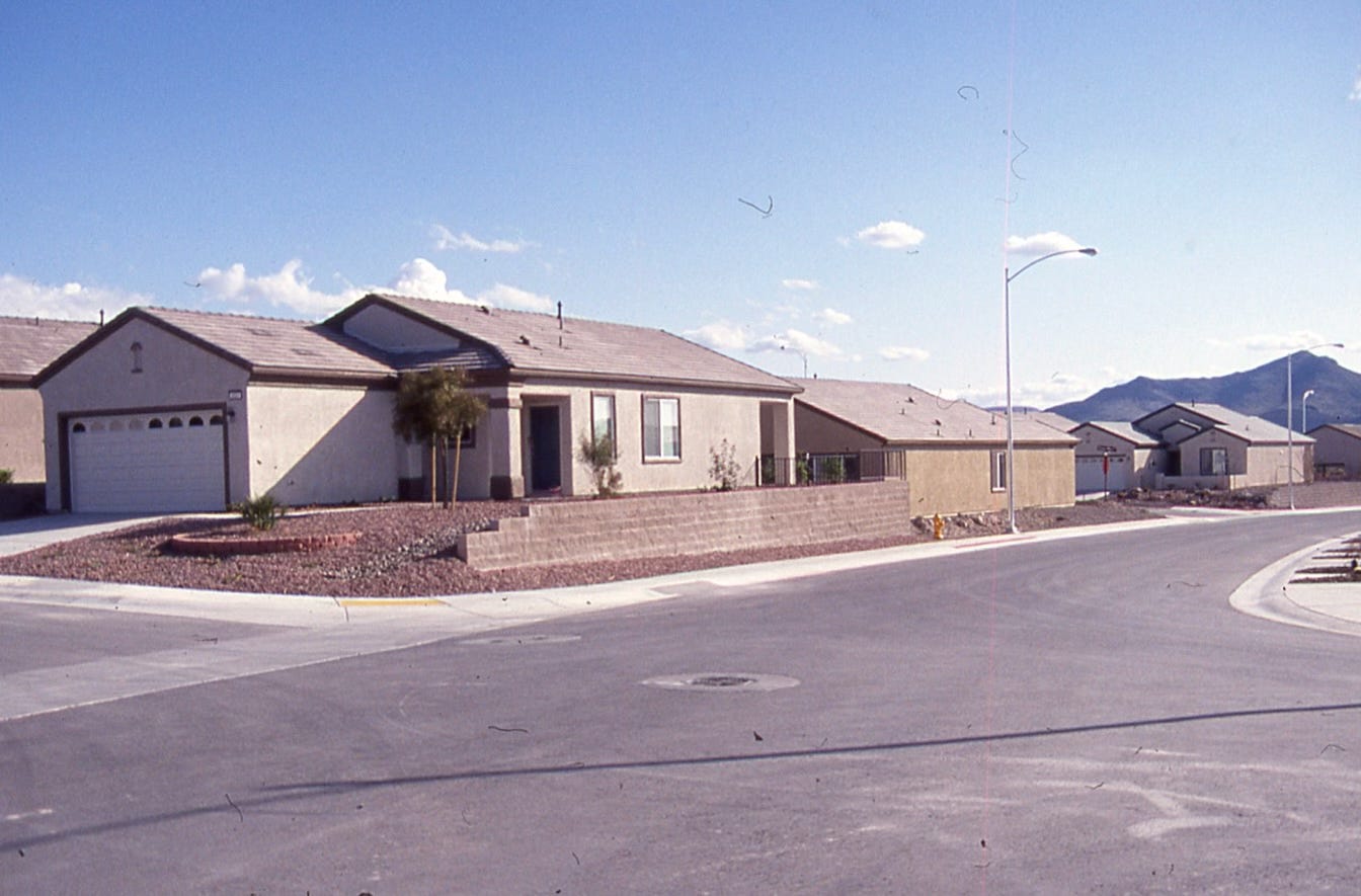Stucco houses with gravel front yards built very close together outside Las Vegas Stucco houses with gravel front yards built very close together outside Las Vegas
