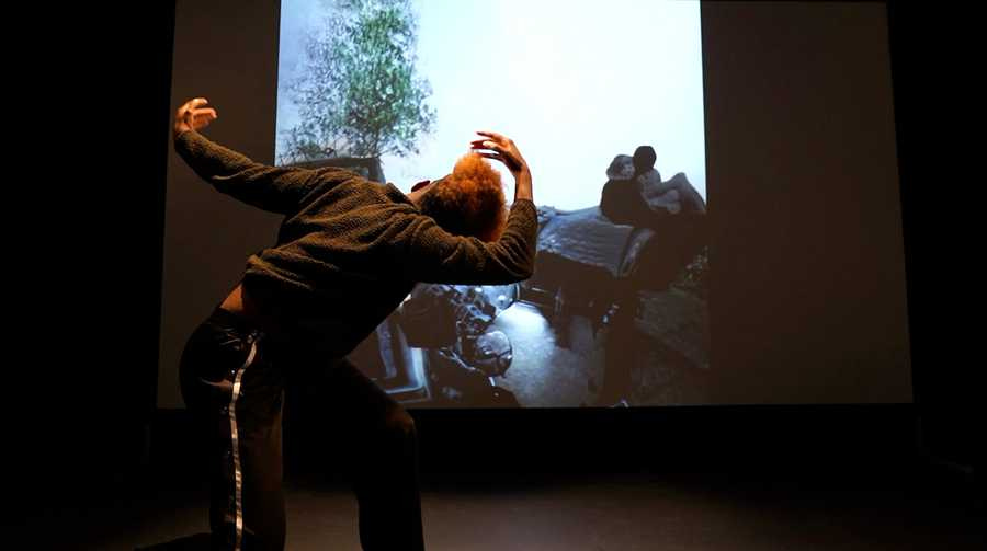 A still of dancer Lenataa S. Goka improvising with Self Absorbed at the Choreographic Coding Lab 2022 in Chatham UK. Photo by Aoi Nakamura. A still of dancer Lenataa S. Goka improvising with Self Absorbed at the Choreographic Coding Lab 2022 in Chatham UK. Photo by Aoi Nakamura.