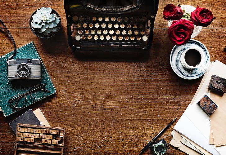 Royalty-Free photo: Black and brown typewriter, red Rose flowers, and gray  Succulent plant | PickPik