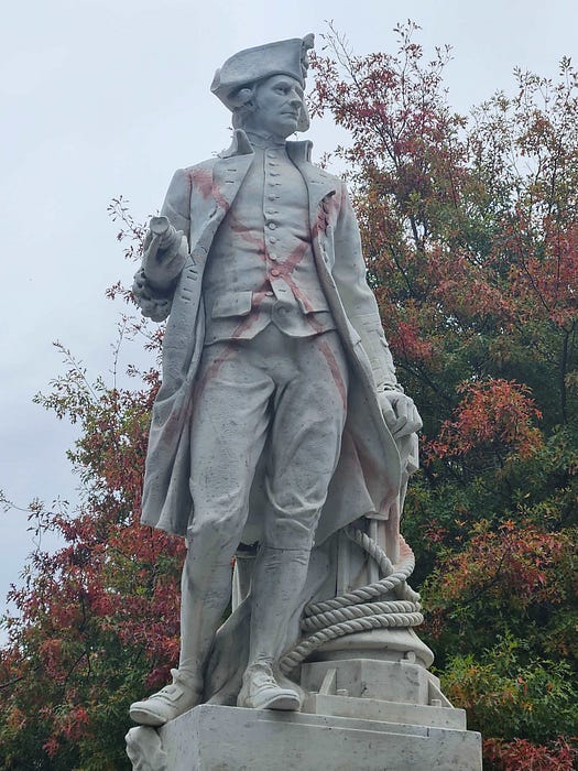 Figure in white marble, Frock coat, telescope tucked under arm, with painted red cross over torso