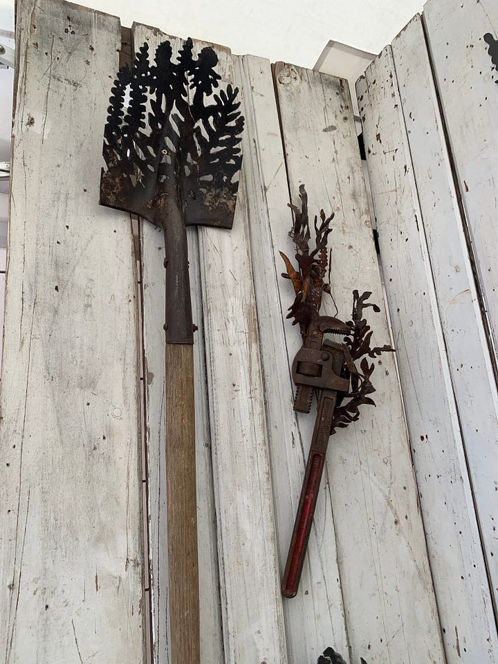 A variety of metal sculptures made from found objects, incorporating rust as a decorative patina.