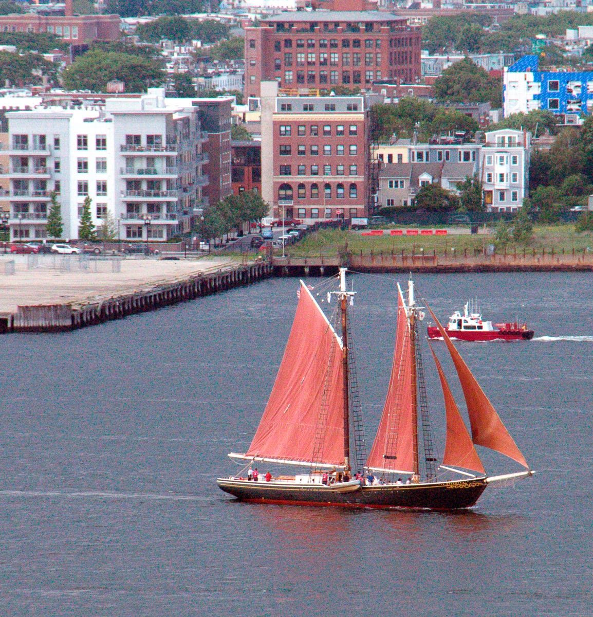 Photo of Schooner Roseway wiht Full Red Sails Flying in Boston Harbor.