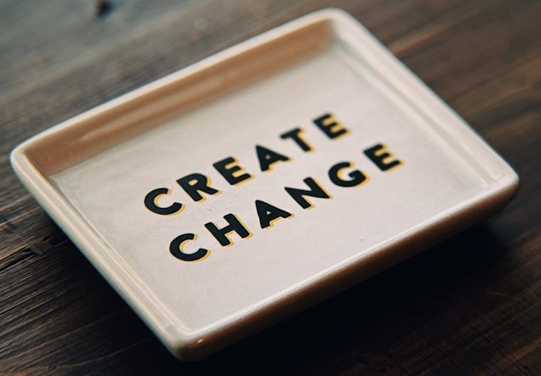 A white tray with the words create change written on it