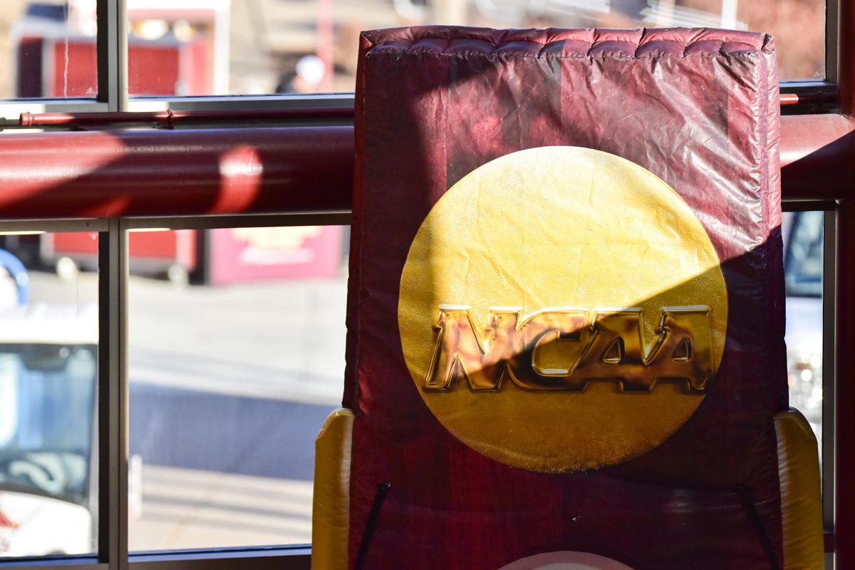the top half of a national championship trophy replica with an NCAA emblem
