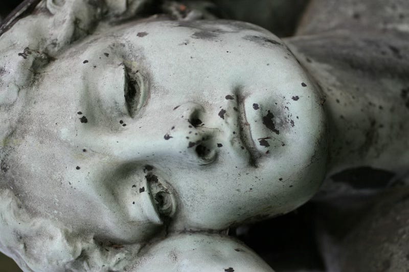 weathered and sad statue. she is considering the role she assumed. weathered and sad statue. she is considering the role she assumed.