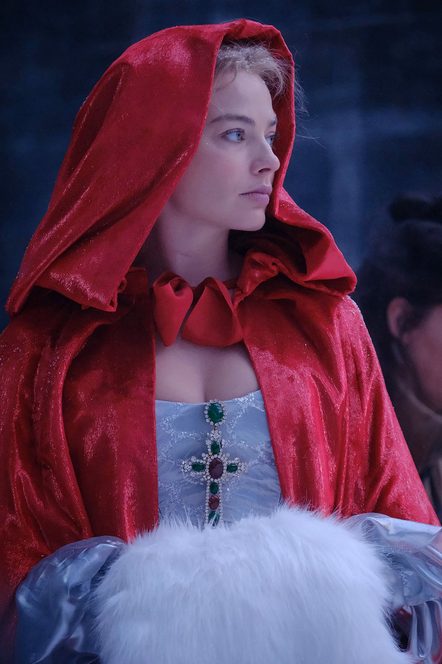 Image may contain Margot Robbie Cape Clothing Fashion Velvet Adult Person Performer Solo Performance Face and Head