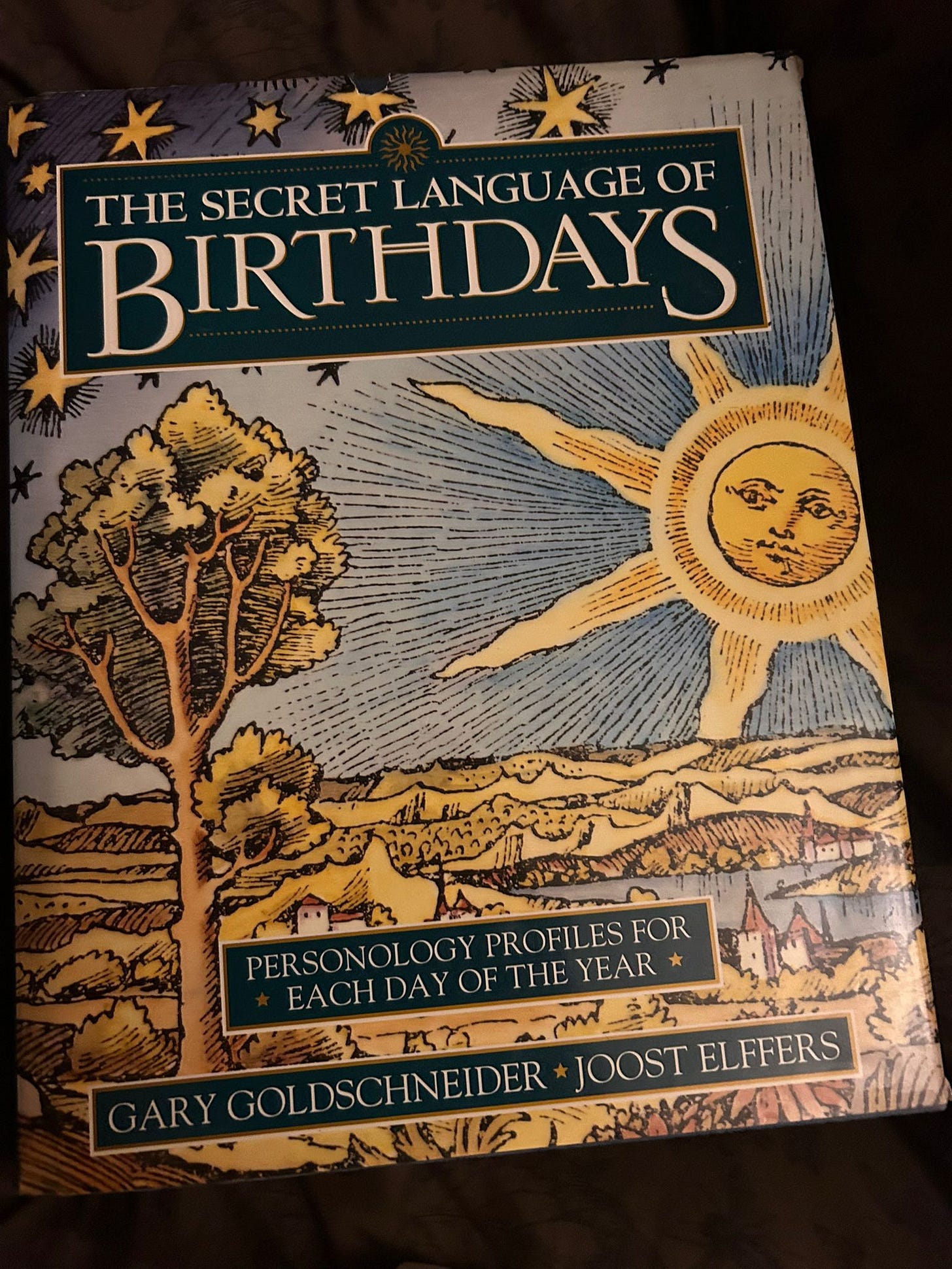 Book cover of The Secret Language of Birthdays by Gary Goldschneider and Joost Elffers showing illustrated sun landscape - personality astrology reference used in tarot conversation. Book cover of The Secret Language of Birthdays by Gary Goldschneider and Joost Elffers showing illustrated sun landscape - personality astrology reference used in tarot conversation.