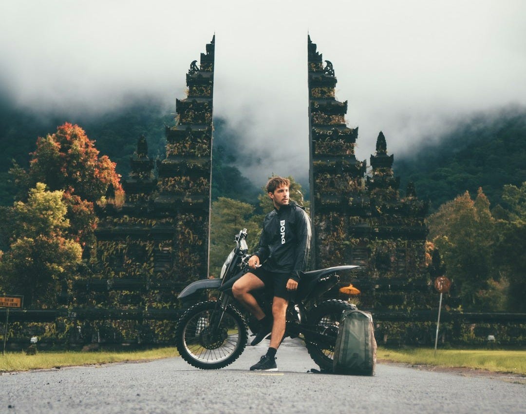 man sitting on dirtbike man sitting on dirtbike