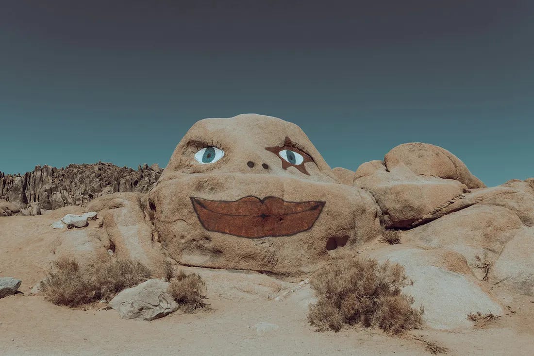 face painted into a rock on a small hill the dersert