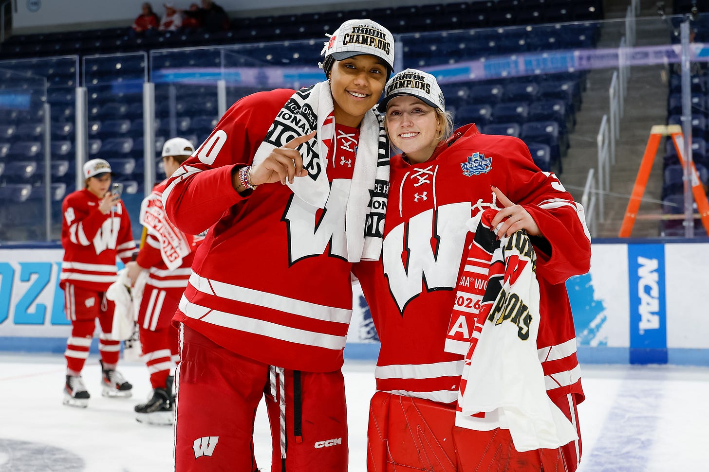 Laila Edwards and Chloe Baker hold up 1 finger to symbolize they are champions