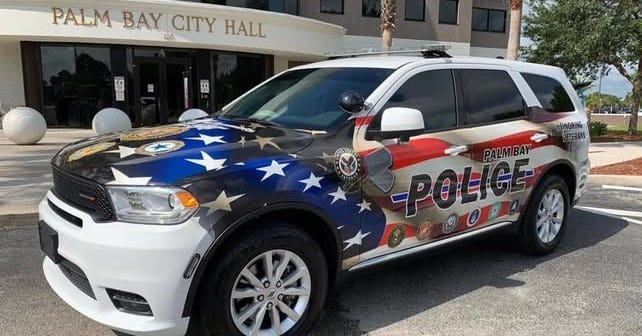 Palm Bay Police SUV decorated with an American flag and law enforcement insignia, parked in front of Palm Bay City Hall. Palm Bay Police SUV decorated with an American flag and law enforcement insignia, parked in front of Palm Bay City Hall.