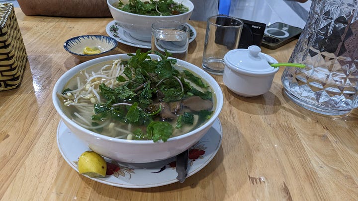bowl of savory soup, restaurant wall