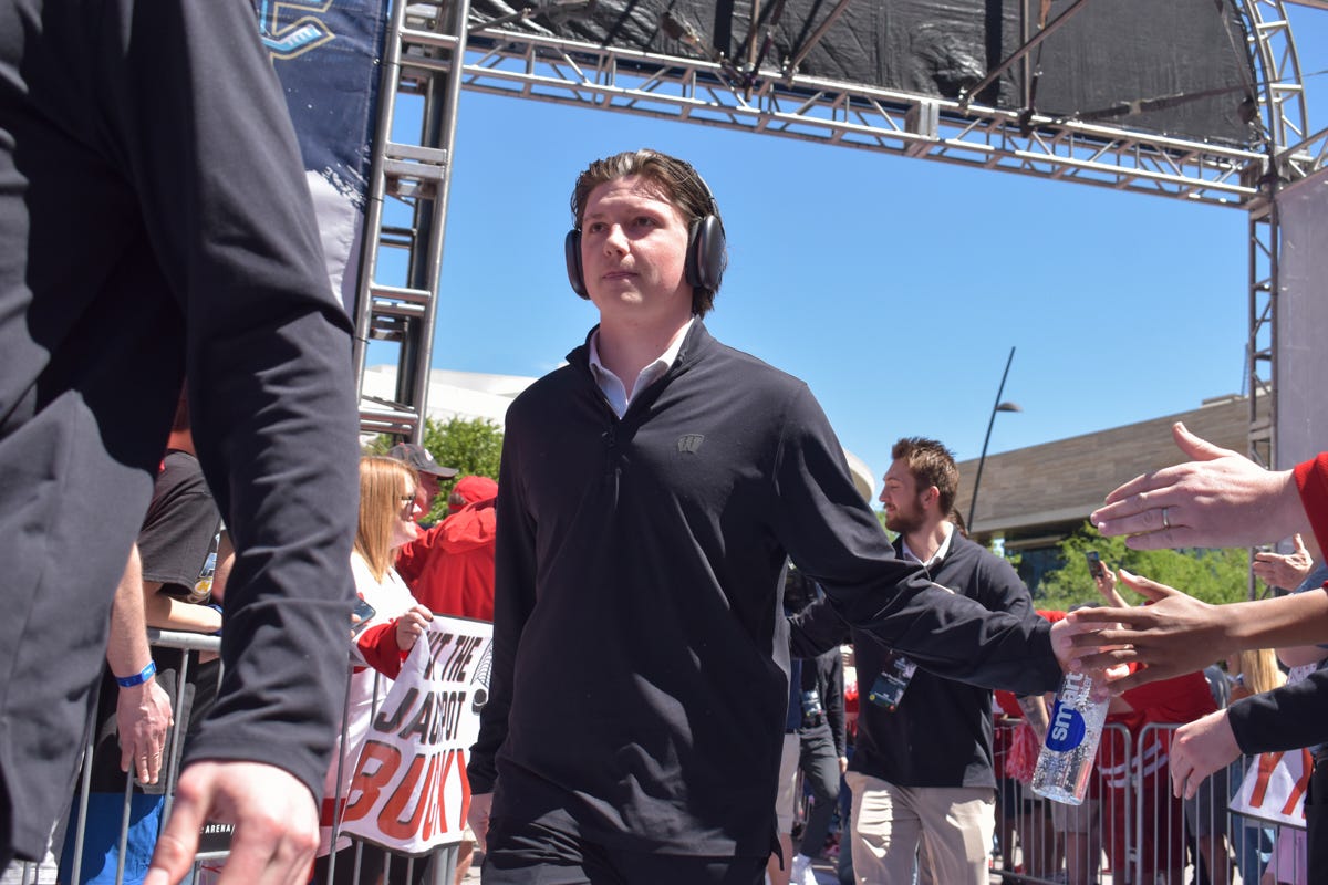 Quinn Finley wears headphones as he walks into T-Mobile Arena