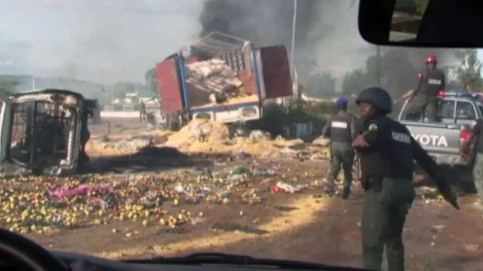 Destroyed vehicles and debris is strewn across the road as police attempt to restore calm in the town of Jos, Nigeria ( AP ) Destroyed vehicles and debris is strewn across the road as police attempt to restore calm in the town of Jos, Nigeria ( AP )