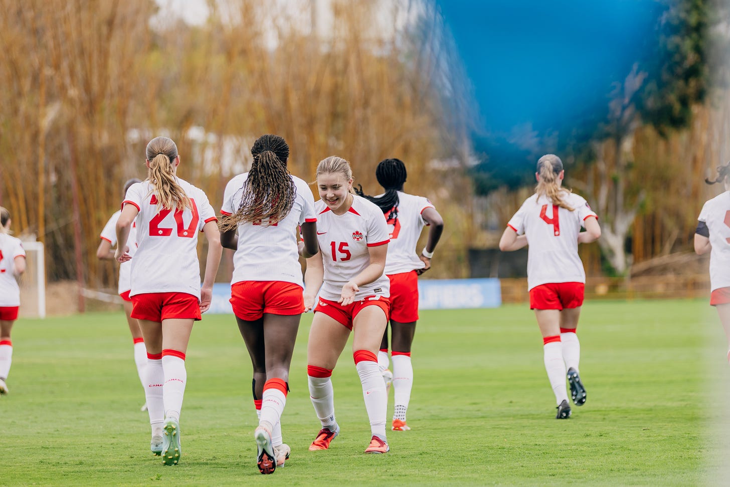 Canadian players celebrate a goal before restarting play