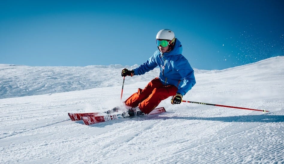 man ice skiing on hill